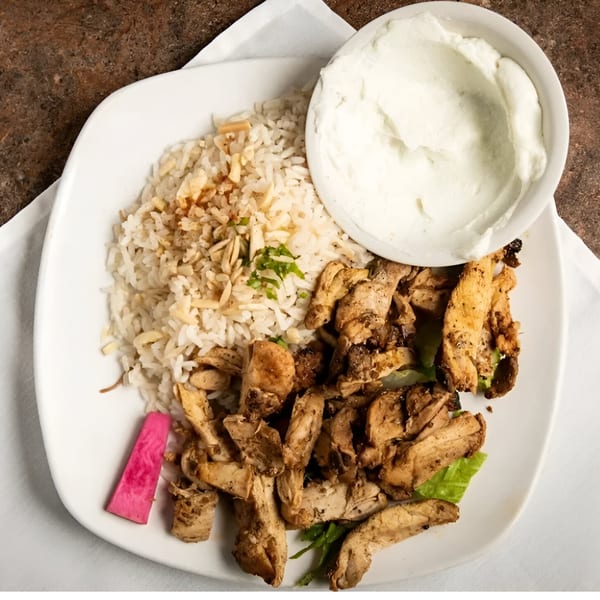 La Marra's chicken shawarma plate with rice, white sauce, and a pink pickle.
